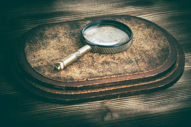 istock Old magnifying glass or loupe on cork background. 924107732