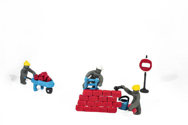 Two toy hands and helmet on blue background.