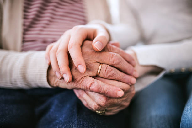 Hands of teenage girl and her grandmother at home. Unrecognizable teenage girl with grandmother at home, holding hands. Family and generations concept. Close up. old hands stock pictures, royalty-free photos & images