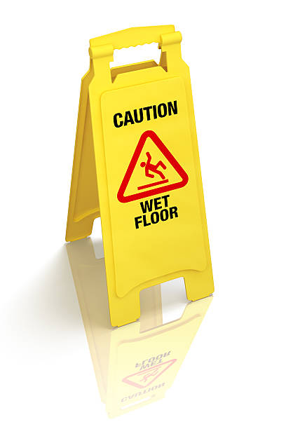 A yellow wet floor sign on a white surface Bright yellow wet floor sign isolated on white. Pro clipping path. sliding down stock pictures, royalty-free photos & images