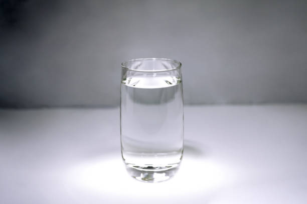 istock A glass with clear water on gray background. 924110826