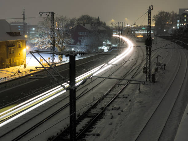 istock Light trail of a train at night in winter 924118702