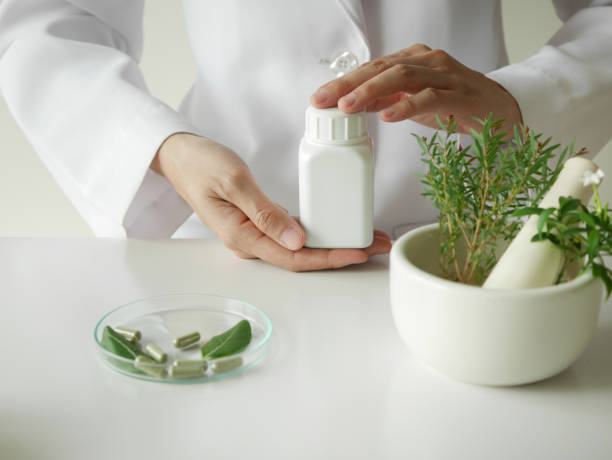 istock scientist or doctor making herbal medicine with herb leaves , capsule, tablets.hands. 924131982