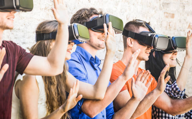 istock Group of friends playing on vr goggles outdoors - Virtual augmented reality and wearable tech concept with young people having fun together with headset - Digital generation trend - Warm bright filter 924134942