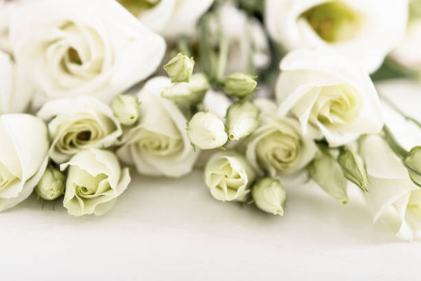 istock Bouquet of white roses on white wooden table 924135694