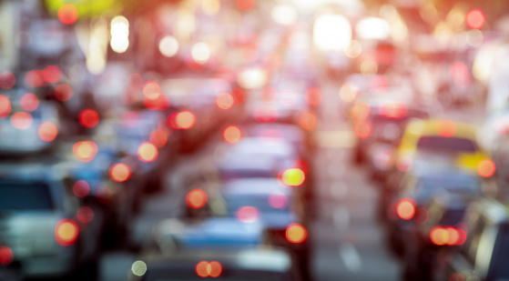 Rush hour with defocused cars and generic vehicles - Traffic jam in Los Angeles downtown - Blurred bokeh postcard of american iconic city with dark contrast sunshine filter - Transportation concept