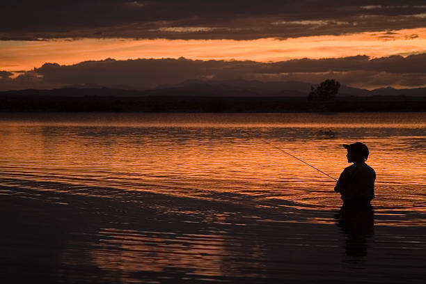 istock Boy Fly Fishing at Sunset 92414152