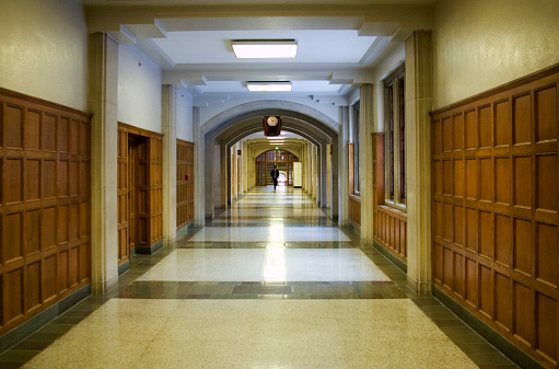 Picture is of a student walking in a Purdue University hallway.