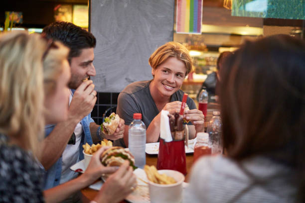 istock Smiling young man looking at friend in restaurant 924150406