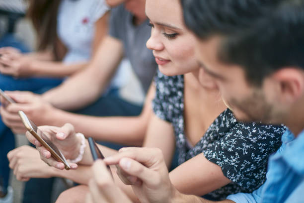 istock Woman using smart phone while sitting with friend 924150550