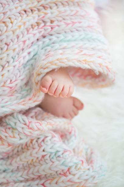 istock baby feet in blanket, copy space. selectiv focus 924159158