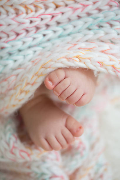 istock baby feet in blanket, copy space. selectiv focus 924159164