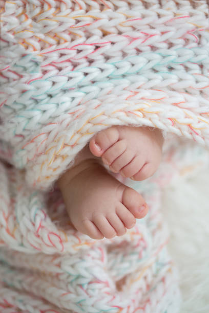 istock baby feet in blanket, copy space. selectiv focus 924159178