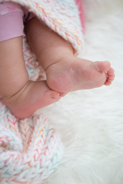 istock Baby feet on blanket showing emotions. Copy space. Selective focus 924159190