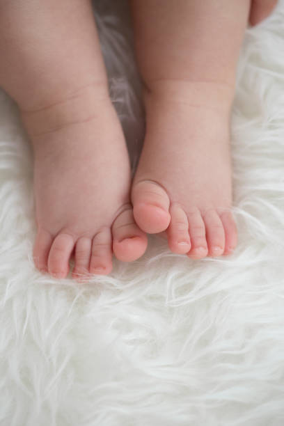 istock Baby feet on blanket showing emotions. Copy space. Selective focus 924159196