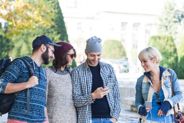 istock Friends walking on street and taking selfie 924159250