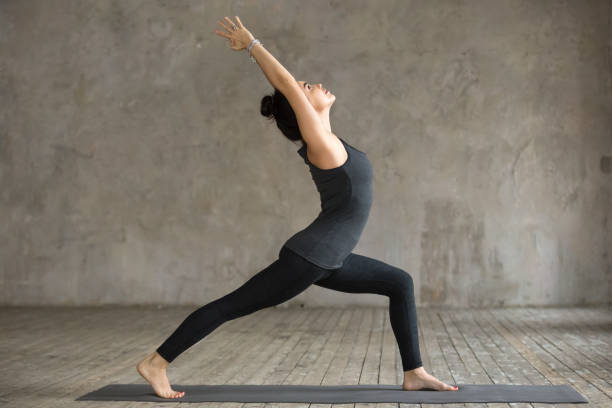 istock Young woman doing Virabhadrasana 1 exercise 924163356