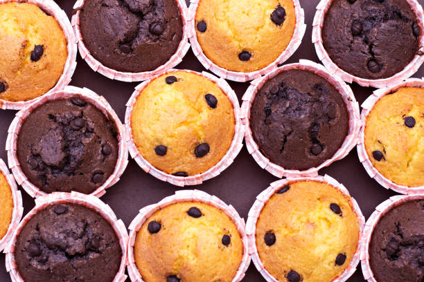 istock Chocolate capcake and vanilla cupcakes with chocolate drops on the table. 924163360