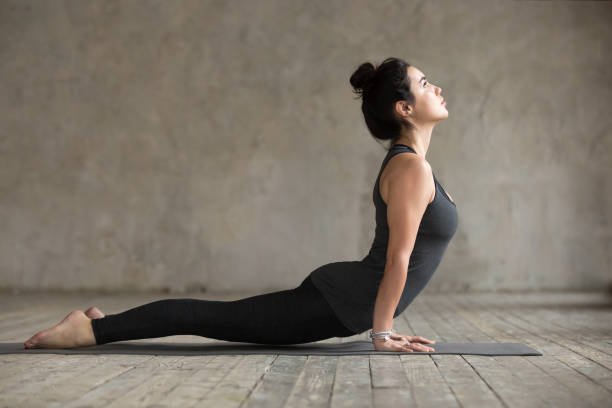istock Young woman doing upward facing dog exercise 924163372