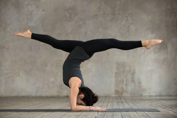 istock Young woman in handstand pose 924163560