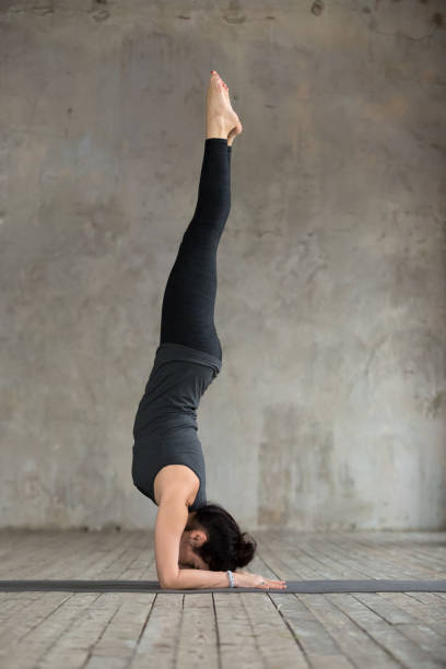 istock Young woman in handstand exercise 924163612