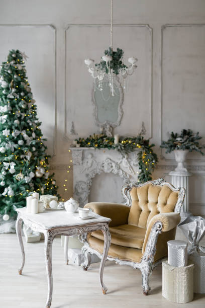 istock Christmas morning . classic apartments with a white fireplace, decorated fir tree, sofa, large windows and chandelier. 924166776