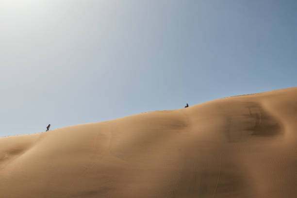 istock People climbing dune, Namibia. Sossusvlei. 924169424