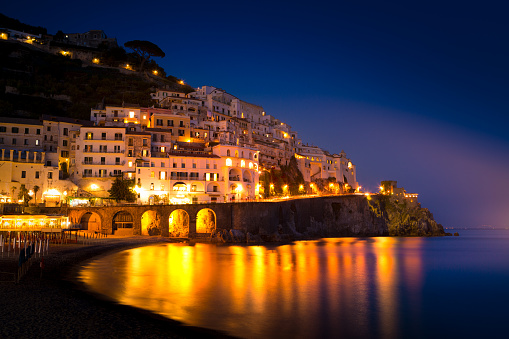 Night view of Amalfi cityscape on coast line of mediterranean sea, Italy