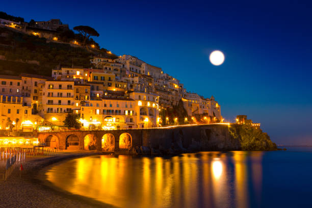 Night view of Amalfi Night view of Amalfi cityscape on coast line of mediterranean sea, Italy sorrento italy photos stock pictures, royalty-free photos & images
