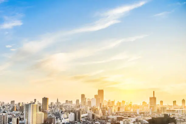 Photo of modern city skyline aerial view of shinjuku area with shinkansen railway under sunset sky in Tokyo, Japan