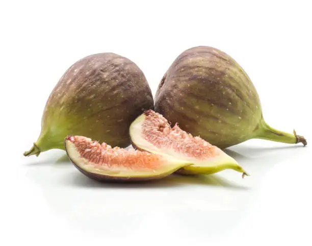 Two green purple figs two slices isolated on white background ripe fresh rose flesh"n