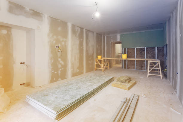 istock Working process of installing metal frames and plasterboard (drywall) for gypsum walls and materials are in apartment is under construction, remodeling, renovation, extension, restoration and reconstruction 924181798