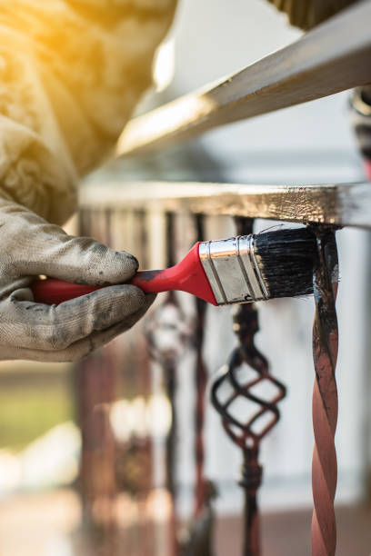 istock Covering forged railings by primer and paint, brush tool, rotection against rust, workflow, sun flare 924182464