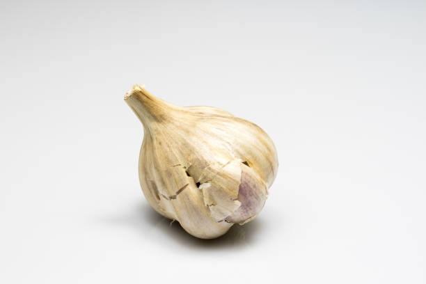 Tasty healthy garlic on white isolated substrate. Vegetables on a white table. Light background