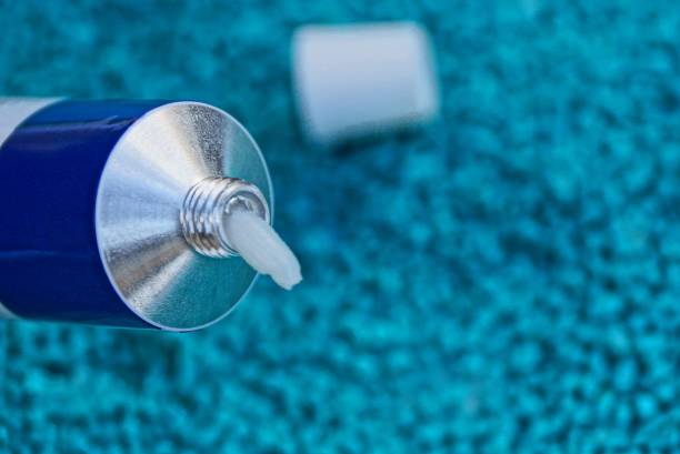 istock open tube with white cream on a blue background 924188612