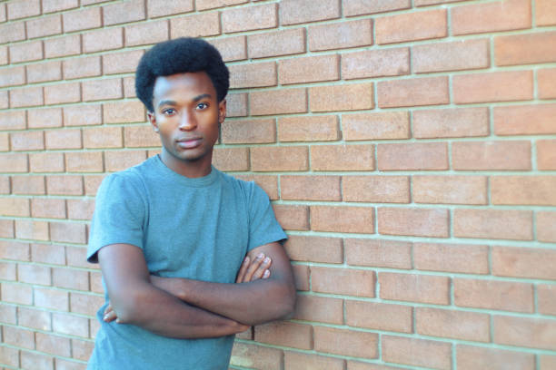 istock young man handsome style crossed arms brick wall urban student 924201866