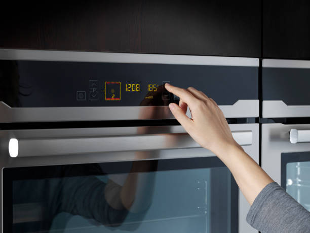 istock Woman using oven in domestic kitchen 924202408