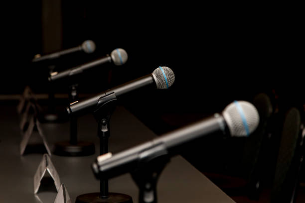 Microphones Microphones in press conference room, prepared for press conference. debate stock pictures, royalty-free photos & images