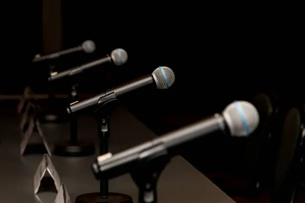 Microphones in press conference room, prepared for press conference.