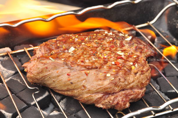 istock BBQ steak on the grill with flames 924214940