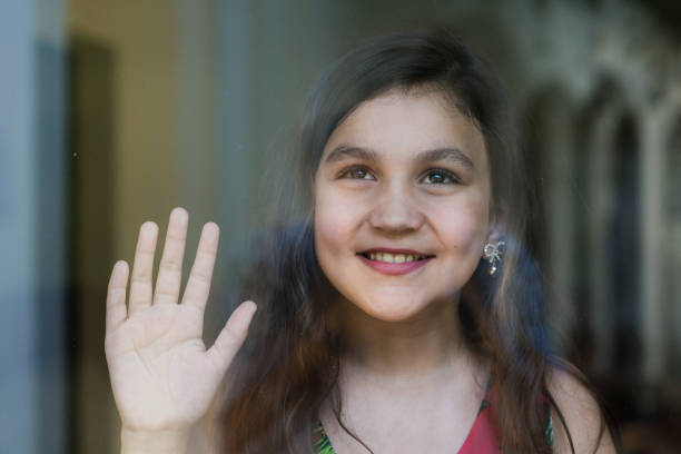 Portrait of a Teen girl behind window glass