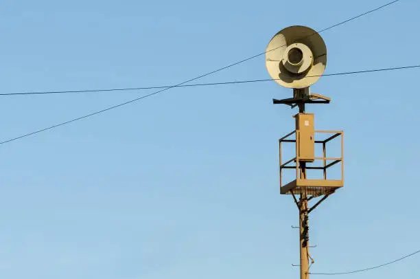 Vintage World War II siren alarm on a pole in Southern California.