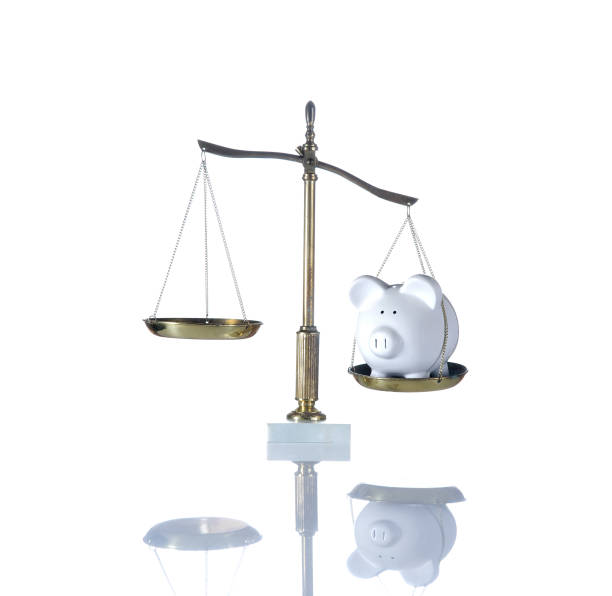 istock Balancing a Piggy Bank and an Empty Weigh Scale. Ready for your concept. 924224836