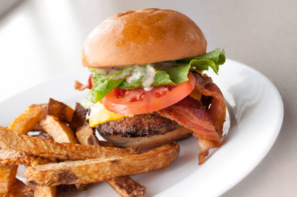 istock Bacon Cheeseburger With Fries On A White Plate 924225000
