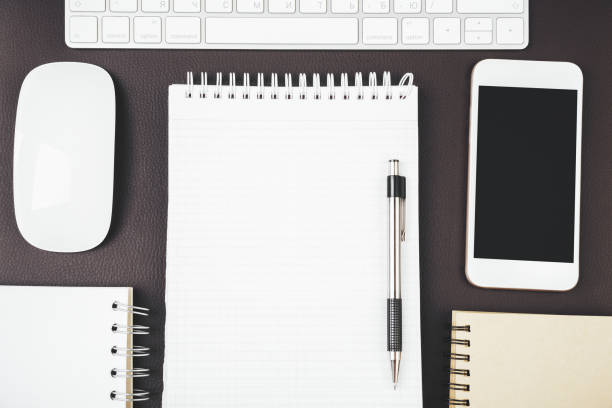 istock Modern desk top with empty smartphone and supplies 924233952