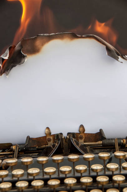 istock Antique typewriter with burning paper with copy space 924236962