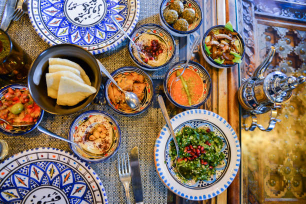 Middle eastern or arabic dishes and assorted meze, concrete rustic background Middle eastern or arabic dishes and assorted meze, concrete rustic background. Meat kebab, falafel, baba ghanoush, muhammara, hummus, sambusak, rice, tahini, kibbeh, pita Halal food Lebanese cuisine middle eastern food photos stock pictures, royalty-free photos & images