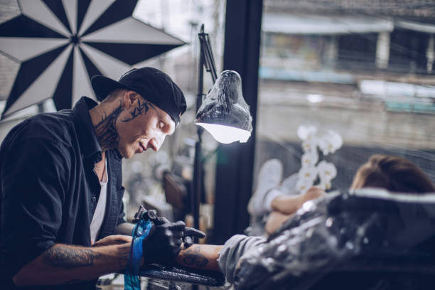 istock Drawing tattoo on young woman's hand in studio 924249944