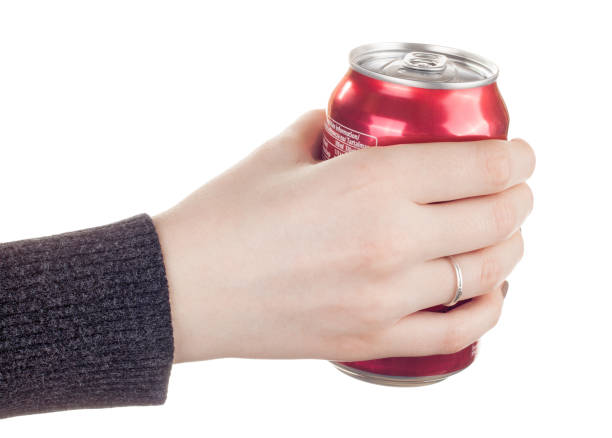 istock Female hand holding a closed can of soda 924252858