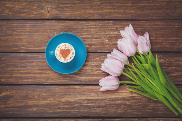 istock Cup of coffee cappuccino with spring tulips 924253882